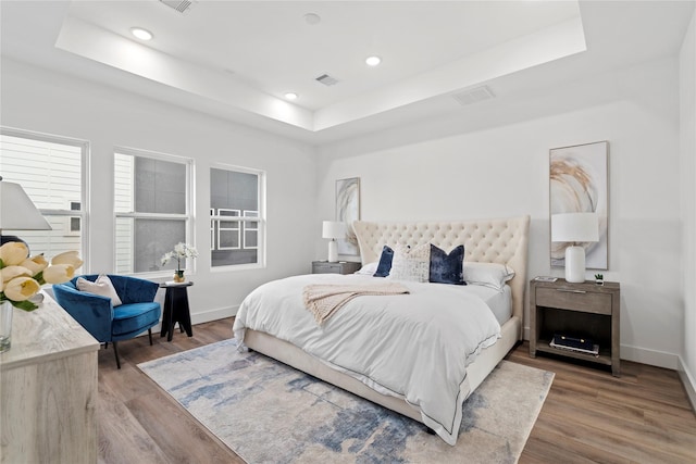 216 E 31st 1/2 St Unit B, Houston, TX 77018 - bedroom featuring a raised ceiling, wood finished floors, and recessed lighting