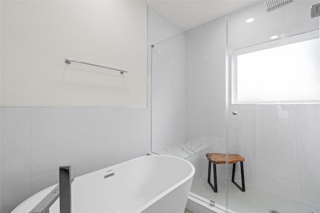 216 E 31st 1/2 St Unit B, Houston, TX 77018 - full bathroom with tile walls, a freestanding tub, and a tile shower