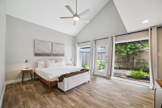 1802 Cedar Creek Ct, Houston, TX 77077 - bedroom featuring access to exterior, high vaulted ceiling, multiple windows, light wood-type flooring, and a ceiling fan