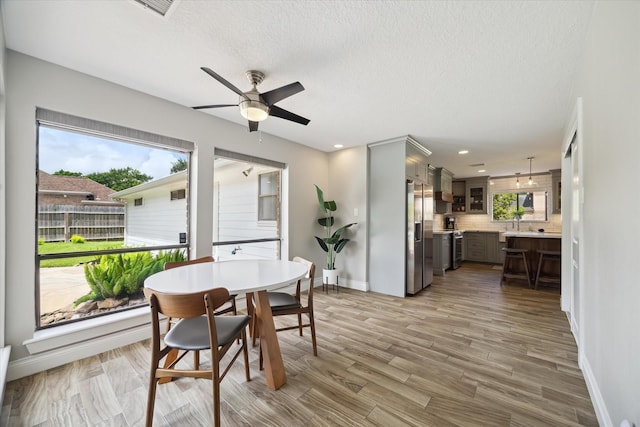 1802 Cedar Creek Ct, Houston, TX 77077 - dining space featuring ceiling fan, plenty of natural light, a textured ceiling, light wood-style flooring, and recessed lighting