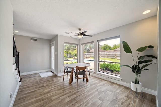 1802 Cedar Creek Ct, Houston, TX 77077 - dining room with light wood-style flooring, a textured ceiling, and ceiling fan
