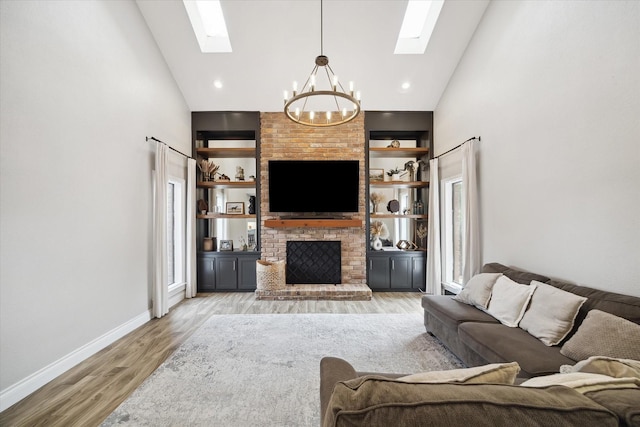1802 Cedar Creek Ct, Houston, TX 77077 - living area featuring a skylight, a chandelier, high vaulted ceiling, a brick fireplace, and light wood-style flooring