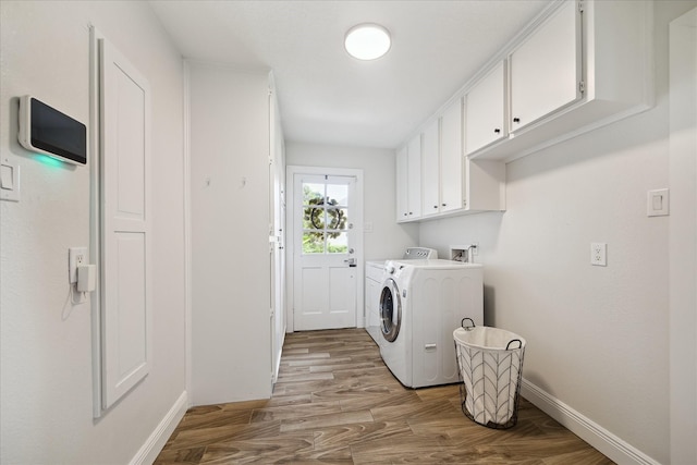 1802 Cedar Creek Ct, Houston, TX 77077 - laundry room with cabinet space, separate washer and dryer, and light wood-style flooring