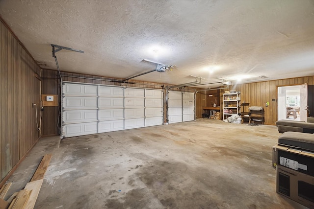 1802 Cedar Creek Ct, Houston, TX 77077 - garage with a garage door opener and wood walls