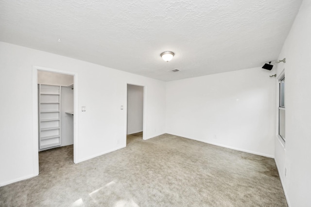 1404 Aldrich St, Houston, TX 77055 - unfurnished bedroom featuring carpet flooring, a spacious closet, and a textured ceiling