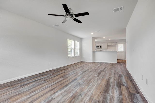 1316 Farquhar St, Navasota, TX 77868 - unfurnished living room featuring healthy amount of natural light, wood finished floors, ceiling fan, and recessed lighting