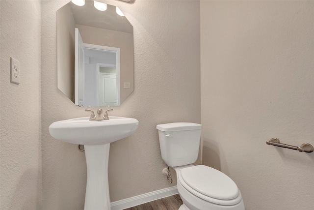 1316 Farquhar St, Navasota, TX 77868 - half bath featuring wood finished floors and toilet