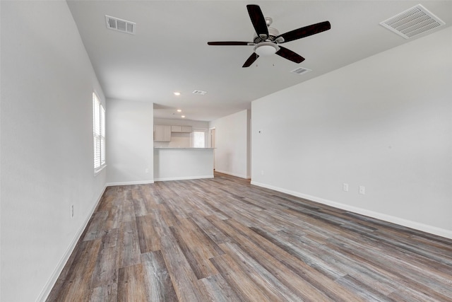 1316 Farquhar St, Navasota, TX 77868 - unfurnished living room featuring wood finished floors, ceiling fan, and recessed lighting