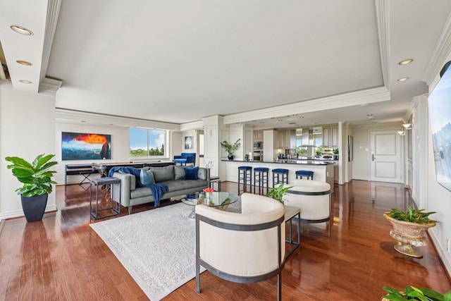 49 Briar Hollow Ln Unit 702, Houston, TX 77027 - living area featuring ornate columns, ornamental molding, dark wood finished floors, recessed lighting, and a tray ceiling