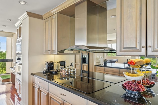 49 Briar Hollow Ln Unit 702, Houston, TX 77027 - kitchen with exhaust hood, recessed lighting, appliances with stainless steel finishes, and dark stone countertops