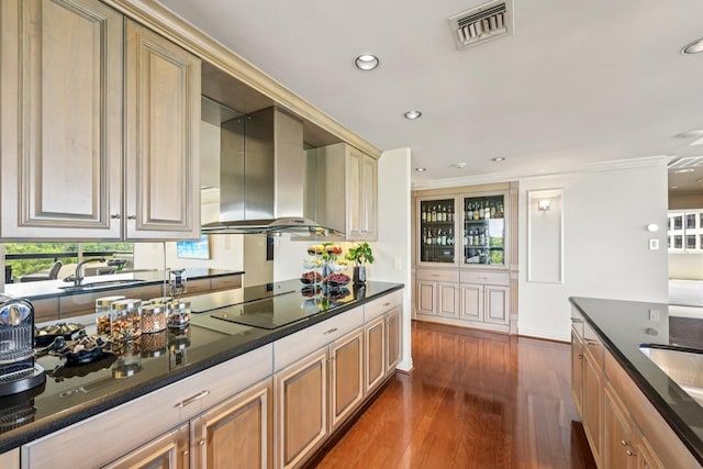 49 Briar Hollow Ln Unit 702, Houston, TX 77027 - kitchen featuring wall chimney range hood, black electric cooktop, dark wood finished floors, recessed lighting, and dark stone counters