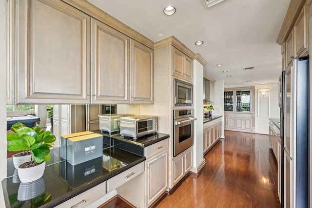 49 Briar Hollow Ln Unit 702, Houston, TX 77027 - kitchen with stainless steel appliances, dark wood finished floors, recessed lighting, and dark countertops