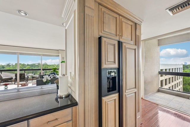 49 Briar Hollow Ln Unit 702, Houston, TX 77027 - kitchen featuring paneled refrigerator with ice dispenser and wood finished floors