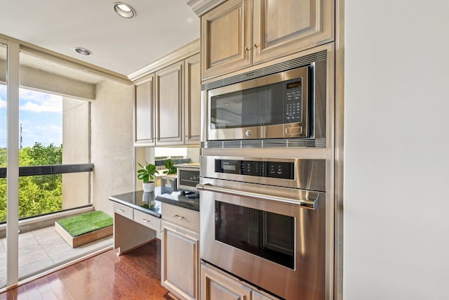49 Briar Hollow Ln Unit 702, Houston, TX 77027 - kitchen featuring appliances with stainless steel finishes, wood finished floors, dark countertops, and recessed lighting