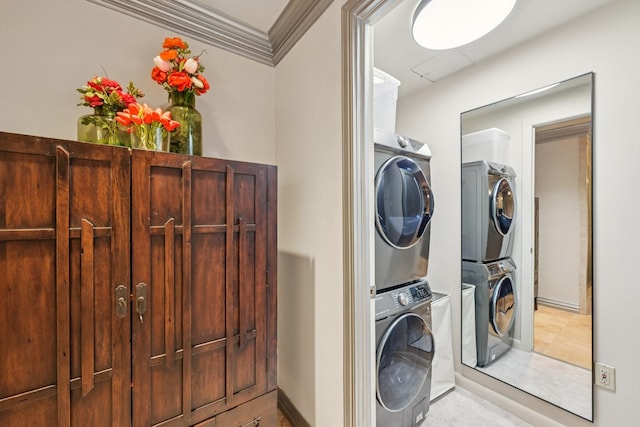 49 Briar Hollow Ln Unit 702, Houston, TX 77027 - laundry area featuring stacked washer / drying machine and ornamental molding