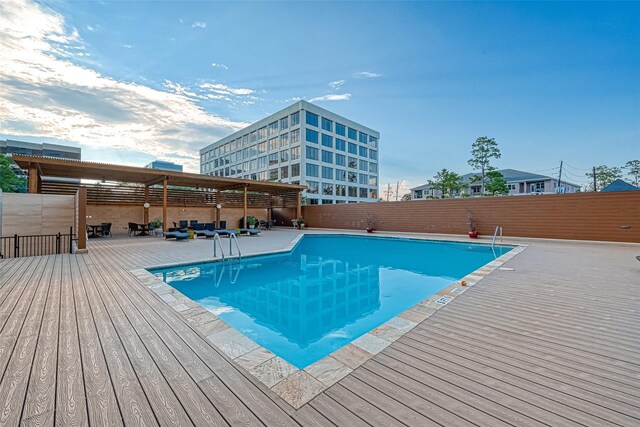 49 Briar Hollow Ln Unit 702, Houston, TX 77027 - community pool featuring a wooden deck and a fenced backyard