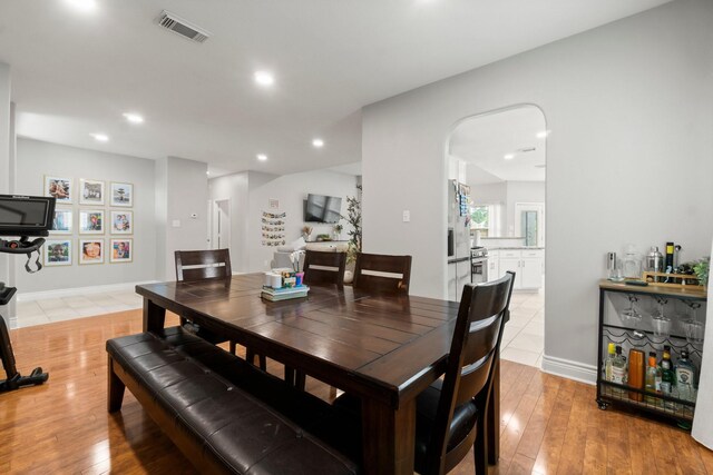 23803 Spring Way Dr, Spring, TX 77373 - dining room featuring arched walkways, light wood-style floors, and recessed lighting