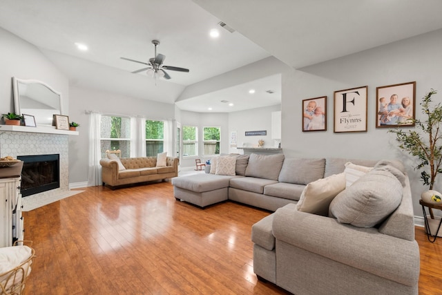 23803 Spring Way Dr, Spring, TX 77373 - living area with ceiling fan, light wood-type flooring, lofted ceiling, a tile fireplace, and recessed lighting
