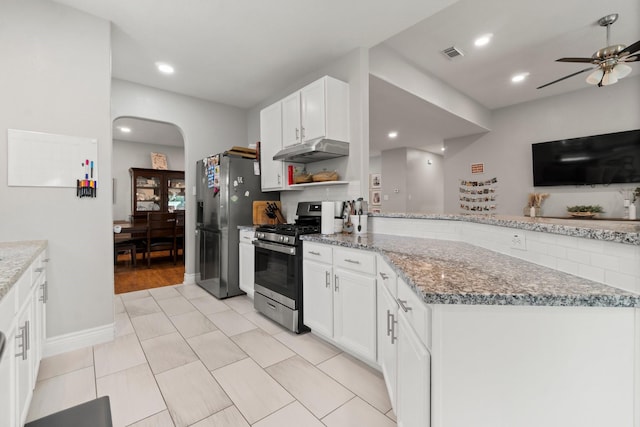23803 Spring Way Dr, Spring, TX 77373 - kitchen featuring stainless steel appliances, under cabinet range hood, a ceiling fan, a peninsula, and light stone counters