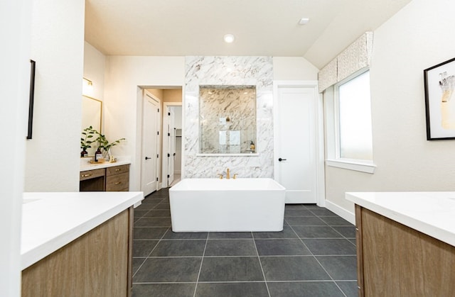 19207 Seabiscuit Stable Trl, Tomball, TX 77377 - full bathroom featuring two vanities, a freestanding bath, and tile patterned floors