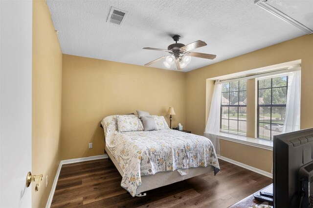 19511 Oak Station Dr, Humble, TX 77346 - bedroom with a textured ceiling, wood finished floors, attic access, and a ceiling fan