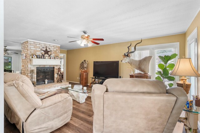 19511 Oak Station Dr, Humble, TX 77346 - living area featuring ceiling fan, wood finished floors, and a brick fireplace