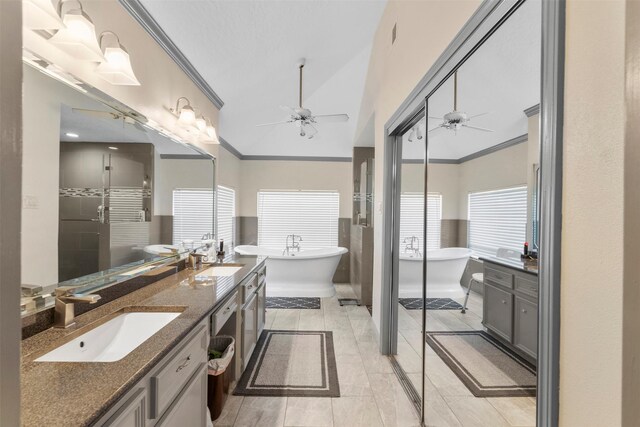 19511 Oak Station Dr, Humble, TX 77346 - full bathroom featuring ceiling fan, double vanity, a stall shower, crown molding, and tile patterned floors