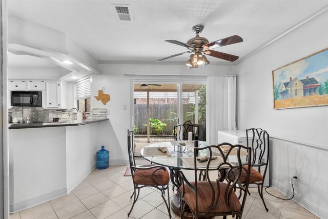 19511 Oak Station Dr, Humble, TX 77346 - dining room with a ceiling fan and light tile patterned floors