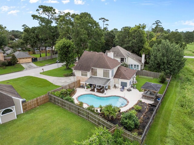 19511 Oak Station Dr, Humble, TX 77346 - back of property featuring a fenced backyard, a shingled roof, a residential view, and a patio area