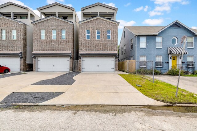 2811 Wichita St, Houston, TX 77004 - townhome / multi-family property featuring concrete driveway, brick siding, and an attached garage