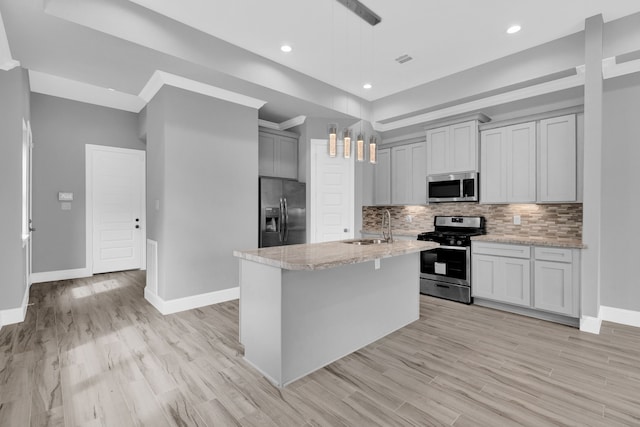 2811 Wichita St, Houston, TX 77004 - kitchen featuring stainless steel appliances, tasteful backsplash, light wood-type flooring, gray cabinets, and light stone counters