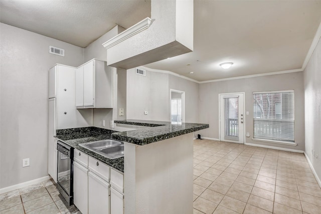 1330 Old Spanish Trl Unit 5106, Houston, TX 77054 - kitchen with black dishwasher, a peninsula, light tile patterned flooring, white cabinets, and ornamental molding