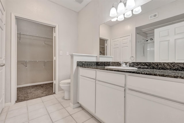 1330 Old Spanish Trl Unit 5106, Houston, TX 77054 - bathroom featuring a shower stall, a walk in closet, vanity, and tile patterned floors