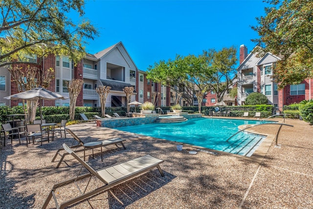 1330 Old Spanish Trl Unit 5106, Houston, TX 77054 - view of swimming pool with a residential view, a pool with connected hot tub, and a patio