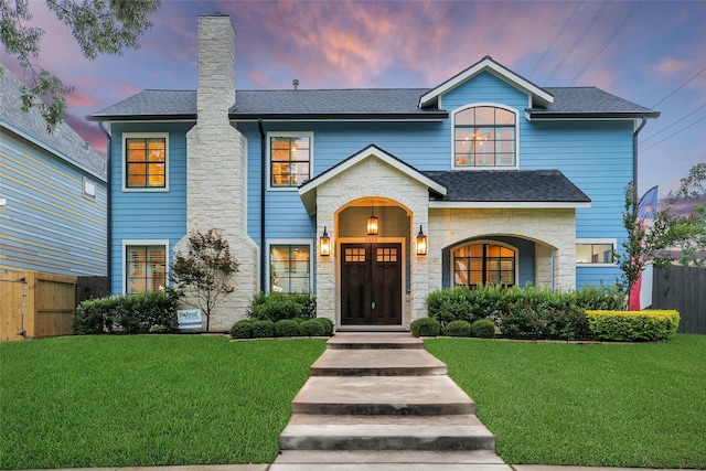 1353 Chantilly Ln, Houston, TX 77018 - view of front of house featuring stone siding, a chimney, and roof with shingles