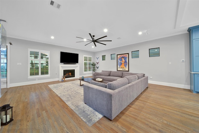 1353 Chantilly Ln, Houston, TX 77018 - living room with ceiling fan, light wood finished floors, a fireplace with flush hearth, ornamental molding, and recessed lighting