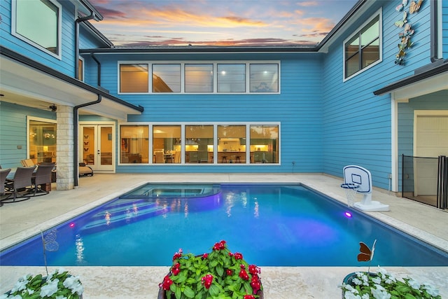1353 Chantilly Ln, Houston, TX 77018 - pool at dusk featuring a patio, french doors, and a pool with connected hot tub
