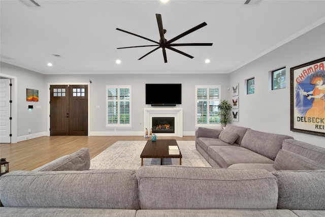1353 Chantilly Ln, Houston, TX 77018 - living room featuring a ceiling fan, light wood-style floors, recessed lighting, and a warm lit fireplace