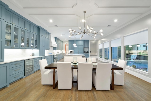 1353 Chantilly Ln, Houston, TX 77018 - dining space with beverage cooler, a chandelier, light wood-type flooring, and recessed lighting