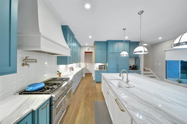1353 Chantilly Ln, Houston, TX 77018 - kitchen featuring premium range hood, blue cabinetry, backsplash, light stone counters, and recessed lighting