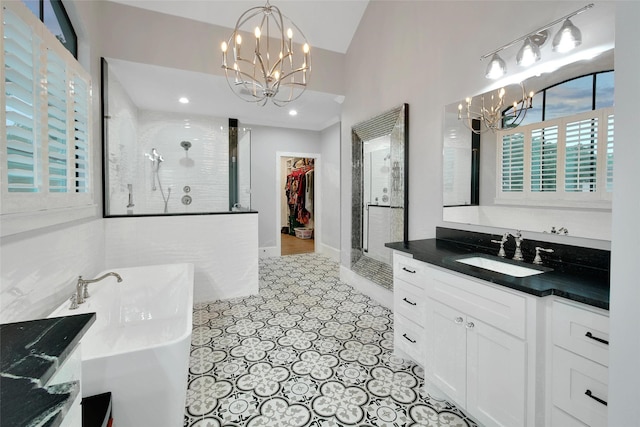 1353 Chantilly Ln, Houston, TX 77018 - full bathroom with a chandelier, a stall shower, vanity, a spacious closet, and a freestanding tub