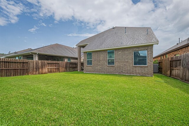 2526 Granberry Pt, Missouri City, TX 77459 - back of house with brick siding, a fenced backyard, and roof with shingles