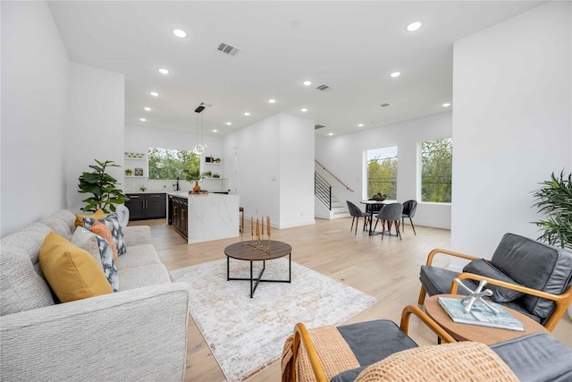 2506 Tierwester St, Houston, TX 77004 - living area with recessed lighting, light wood finished floors, and stairway
