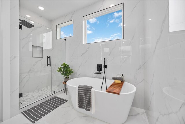 2506 Tierwester St, Houston, TX 77004 - full bathroom with marble tiled floors, a marble finish shower, a soaking tub, and tile walls