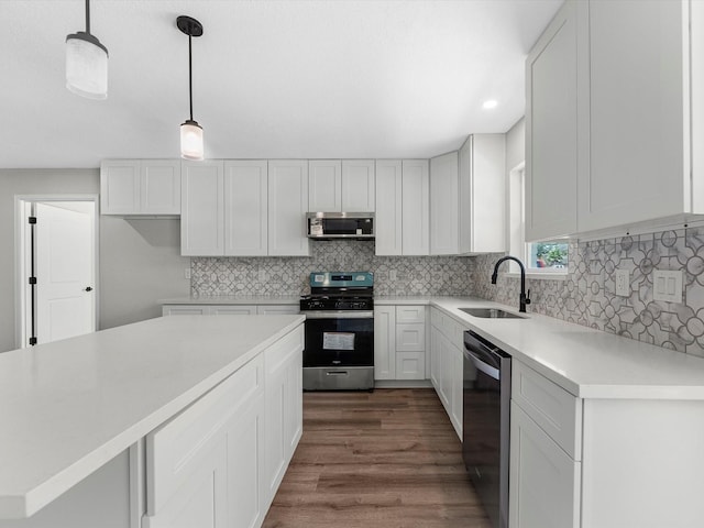 2515 Garapan St, Houston, TX 77091 - kitchen featuring appliances with stainless steel finishes, dark wood-type flooring, tasteful backsplash, light countertops, and recessed lighting