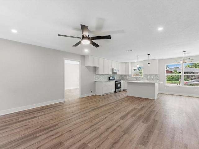 2515 Garapan St, Houston, TX 77091 - unfurnished living room featuring ceiling fan, light wood-style floors, and recessed lighting