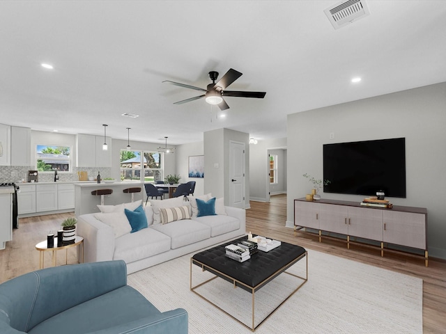 2515 Garapan St, Houston, TX 77091 - living room with light wood-style floors, ceiling fan, and recessed lighting