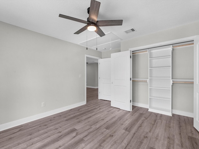 2515 Garapan St, Houston, TX 77091 - unfurnished bedroom with wood finished floors, attic access, a closet, and ceiling fan