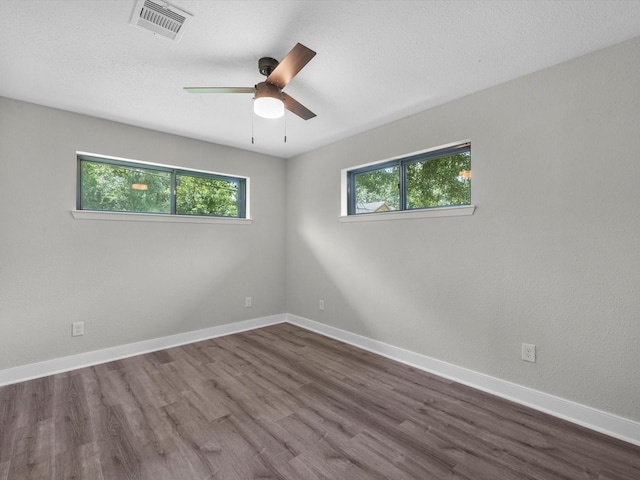 2515 Garapan St, Houston, TX 77091 - empty room with a ceiling fan and dark wood-type flooring