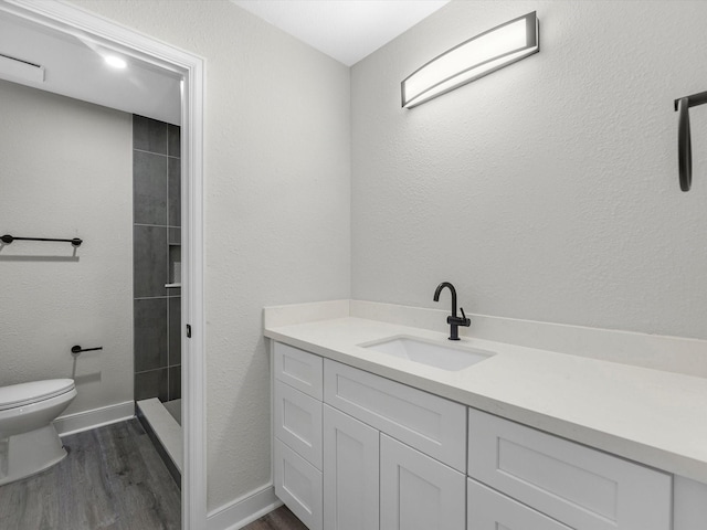 2515 Garapan St, Houston, TX 77091 - bathroom with wood finished floors, vanity, and a tile shower